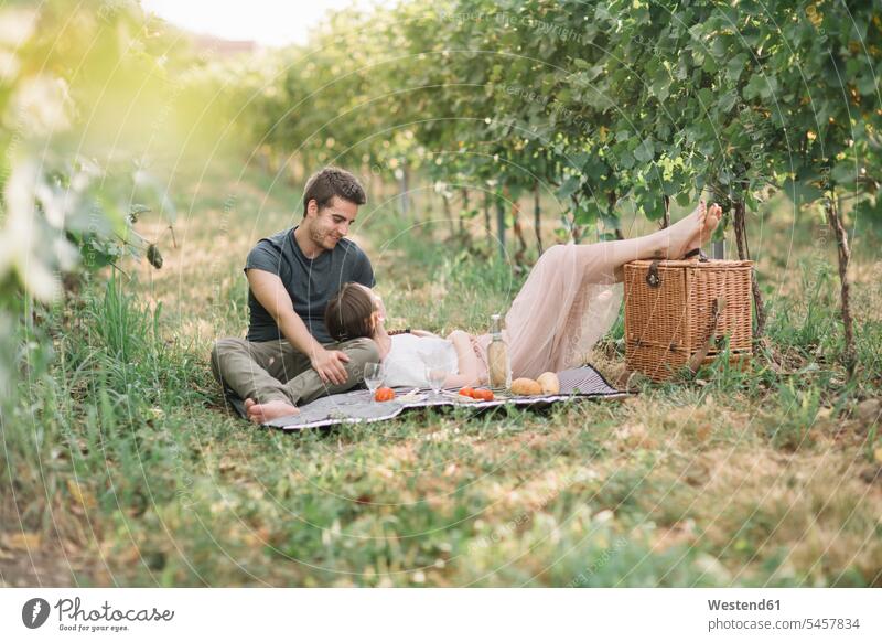Young couple in love having picnic in the vineyards smile relax relaxing relaxation happy Emotions Feeling Feelings Sentiment Sentiments loving closeness