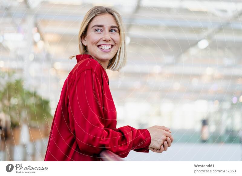 Portrait of a happy young businesswoman standing at a railing business life business world business person businesspeople business woman business women