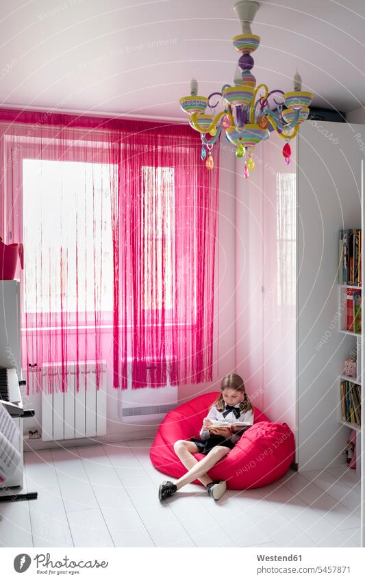 Girl reading a book in her room caucasian caucasian ethnicity caucasian appearance European comfortable furnishing Furnishings well-dressed dressed up childhood