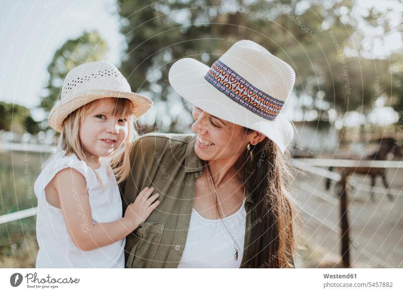 Close-up of mother carrying cute daughter while standing outdoors color image colour image Spain leisure activity leisure activities free time leisure time