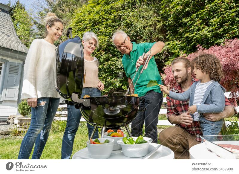 Extended family having a barbecue in garden generation human human being human beings humans person persons families Multi Generations Families