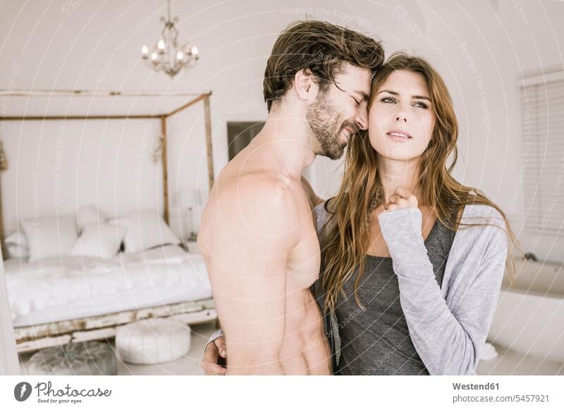 Affectionate young couple in bedroom Bed - Furniture beds relax relaxing cuddle snuggle snuggling smile embrace Embracement hug hugging relaxation delight