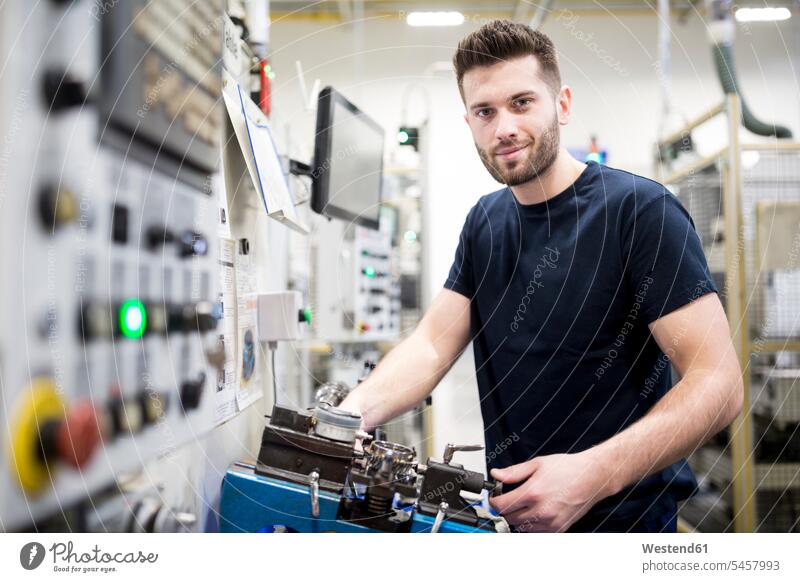 Portrait of a confident man working in a modern factory at a machine Occupation Work job jobs profession professional occupation blue collar blue collar worker