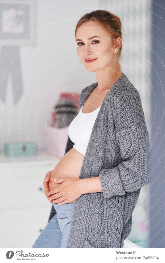 Pregnant woman holding baby belly baby bump pregnant belly portrait portraits females women children's room Kids Room nursery child's room Pregnant Woman