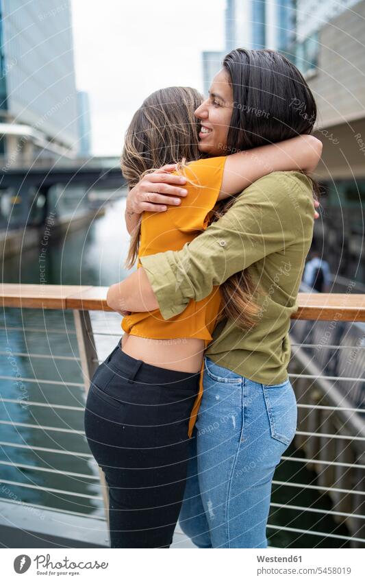 Happy lesbian couple hugging in the city, London, UK smile embrace Embracement delight enjoyment Pleasant pleasure happy Emotions Feeling Feelings Sentiment