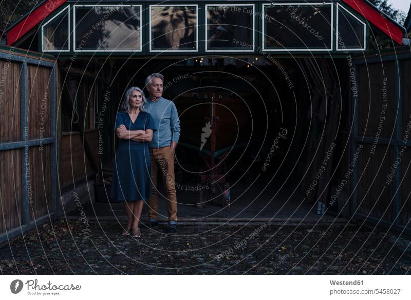 Senior couple standing in front of boathouse human human being human beings humans person persons caucasian appearance caucasian ethnicity european 2 2 people