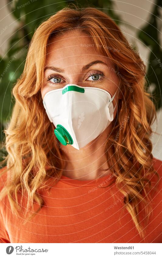 Portrait of red-haired woman wearing a FFP2 mask at home human human being human beings humans person persons caucasian appearance caucasian ethnicity european