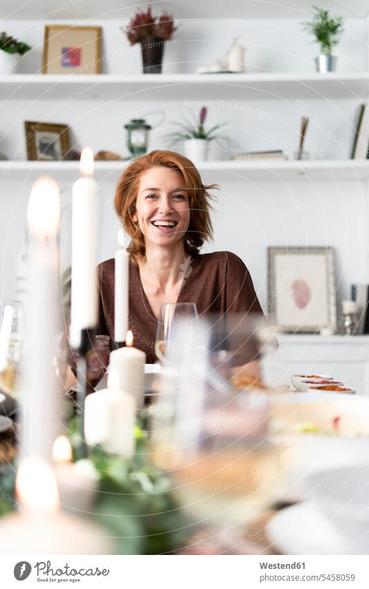 Portrait of a readheaded woman sitting at a dinner party celebrating celebrate partying festive young women young woman Seated Dinner Party Dining Table