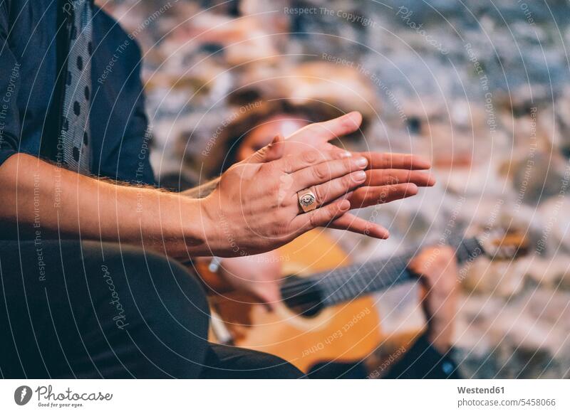 Close-up of singer clapping hands while man playing guitar in club color image colour image Spain indoors indoor shot indoor shots interior interior view
