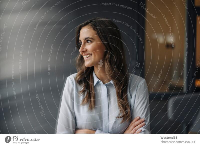 Portrait of happy young businesswoman looking sideways Success successful gray grey Office Offices thinking Vision Visions Inspiration intuitional Intuition