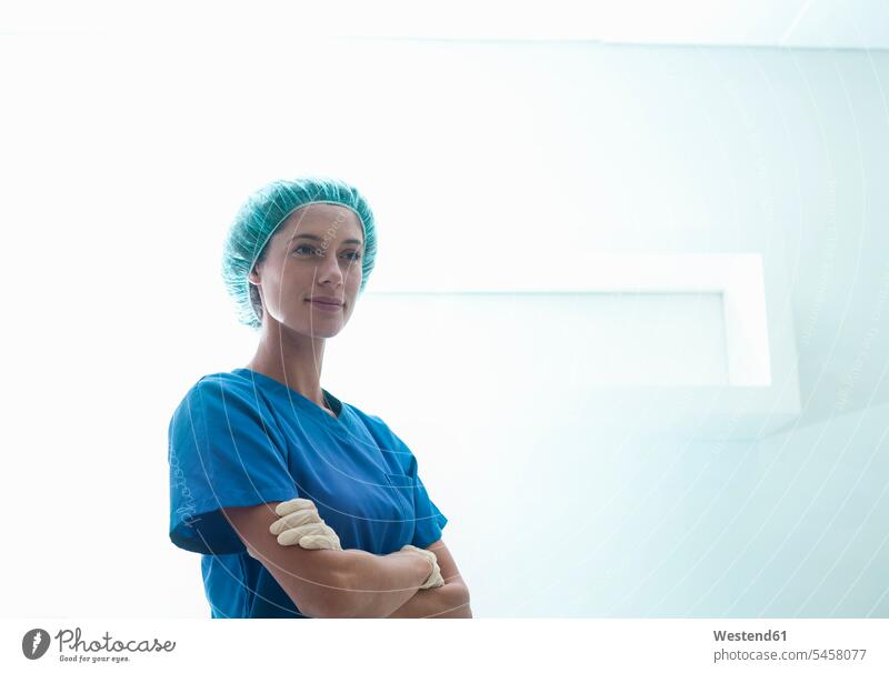 Confident female surgeon standing with arms crossed in intensive care unit at hospital color image colour image South Africa indoors indoor shot indoor shots
