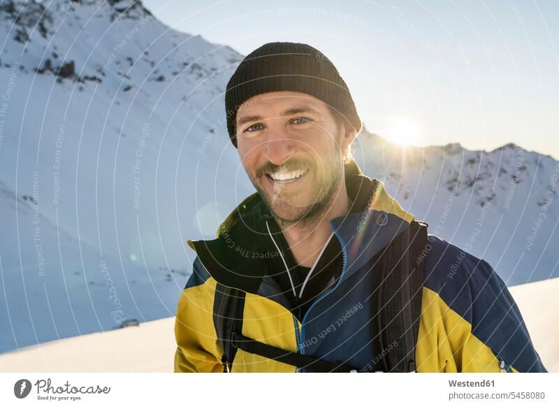 Portrait of man during ski tour, Lenzerheide, Grisons, Switzerland coat coats jackets caps hat hats smile seasons hibernal delight enjoyment Pleasant pleasure