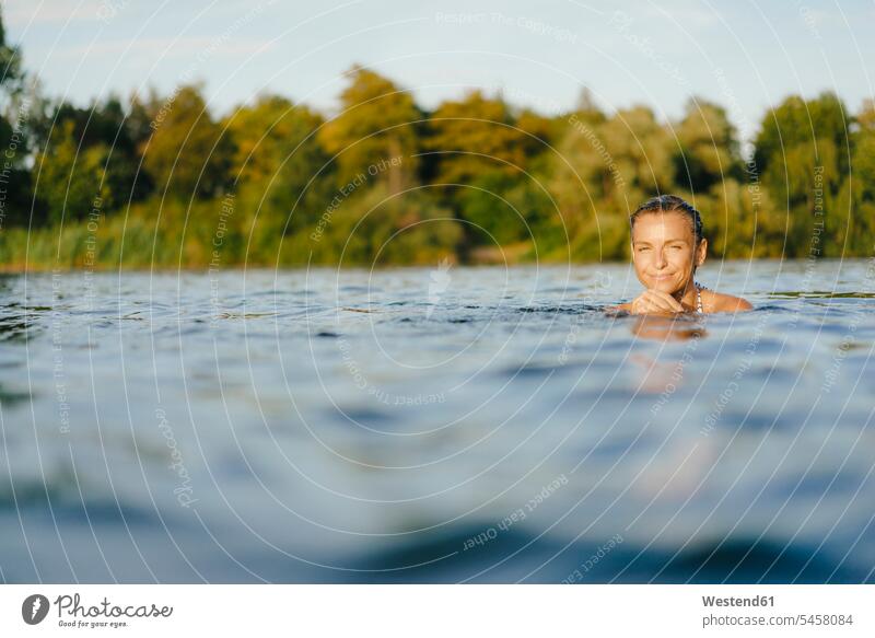 Portrait of smiling woman swimming in a lake females women lakes portrait portraits smile Adults grown-ups grownups adult people persons human being humans