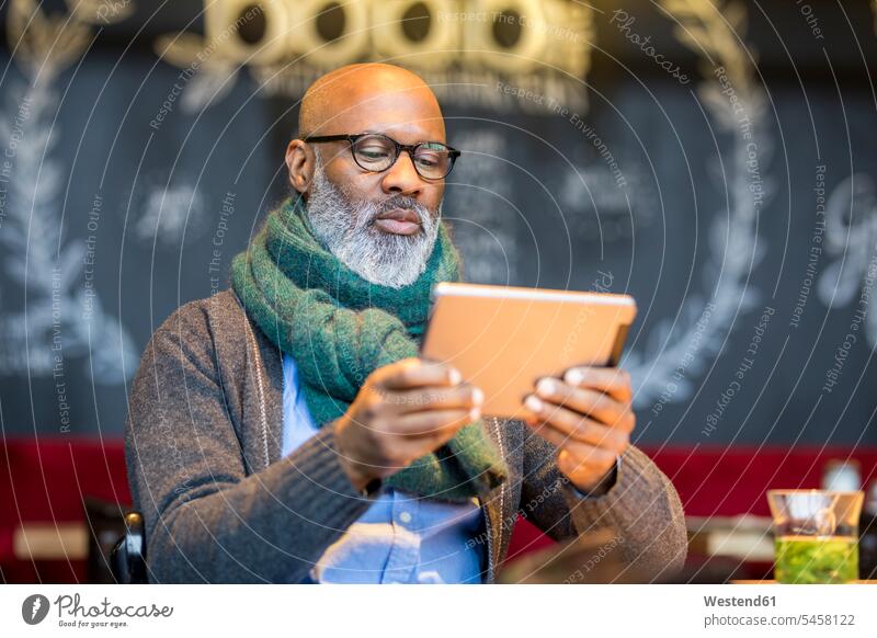 Portrait of man using tablet in a coffee shop cafe portrait portraits digitizer Tablet Computer Tablet PC Tablet Computers iPad Digital Tablet digital tablets