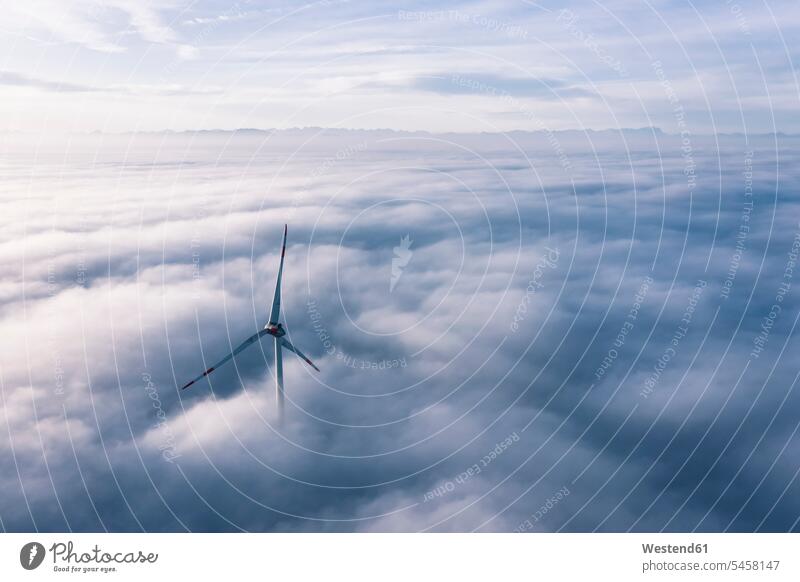 Germany, Aerial view of wind turbine shrouded in clouds at dawn outdoors location shots outdoor shot outdoor shots aerial view bird's eye view bird's eye views