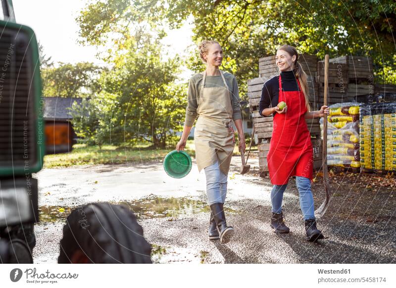 Two smiling women working on a farm smile At Work spade spades confidence confident woman females agriculture Adults grown-ups grownups adult people persons