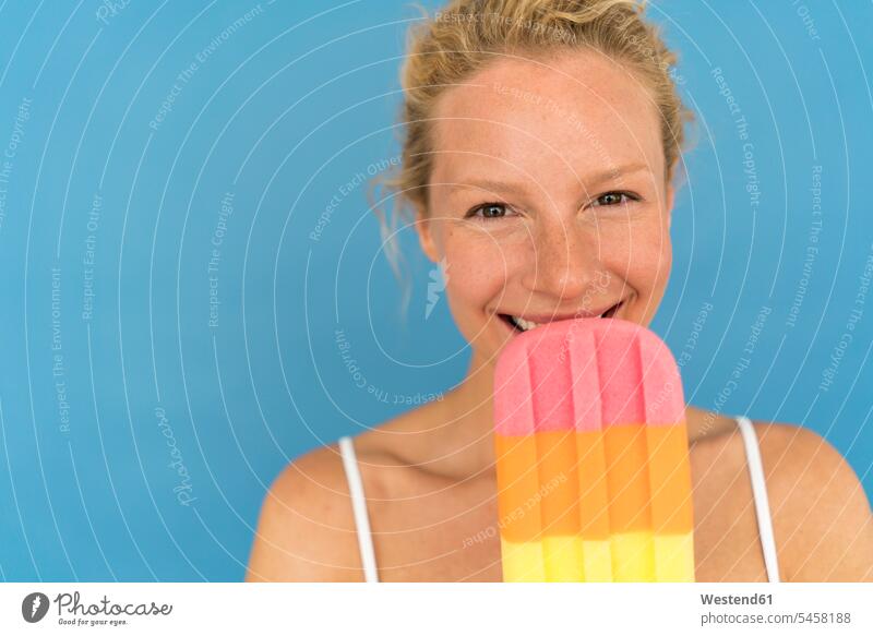 Portrait of blond woman with big popsicle, blue background human human being human beings humans person persons caucasian appearance caucasian ethnicity