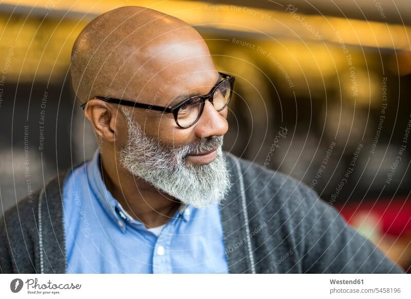 Portrait of bald man with grey beard wearing glasses baldy bald head men males portrait portraits coffee shop cafe specs Eye Glasses spectacles Eyeglasses
