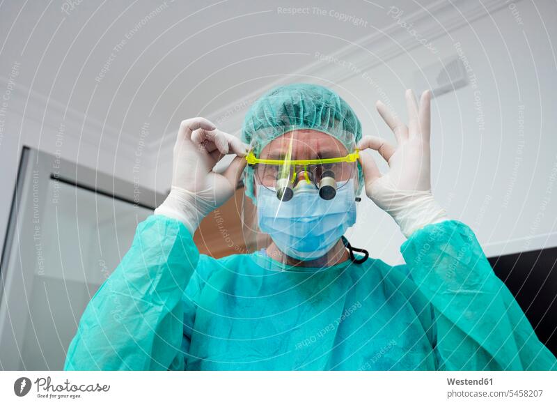 Close-up of male dentist wearing loupe in hospital color image colour image indoors indoor shot indoor shots interior interior view Interiors