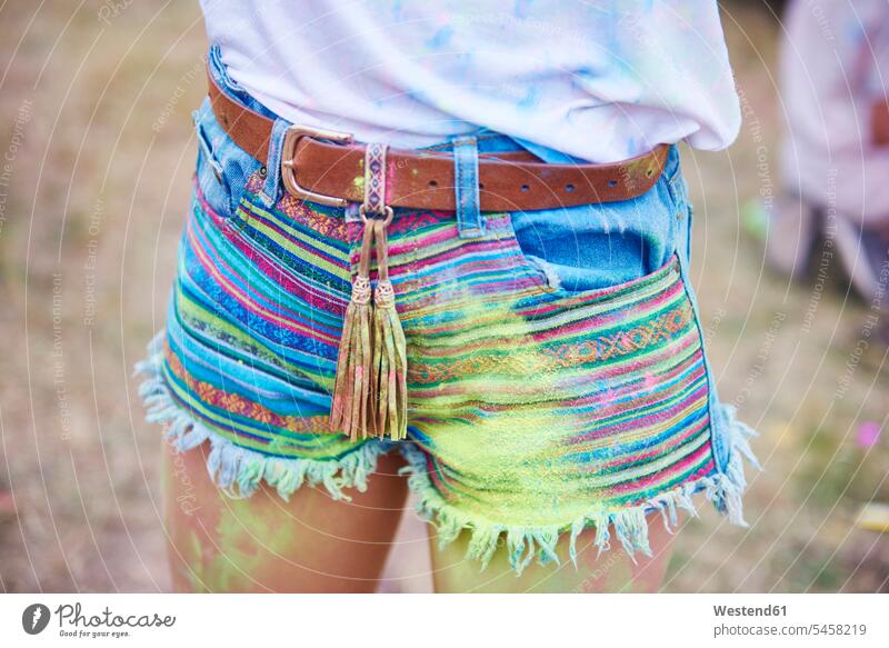Woman's legs with holi colors powder powders paint colour Paints colours jeans shorts hippie Hippy hippies flower children Flower power multi-coloured