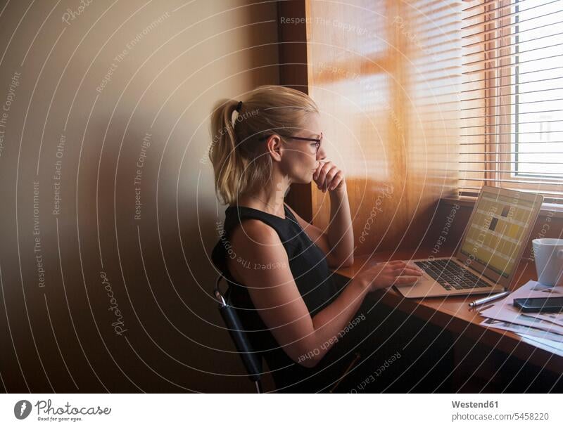 Young woman working on laptop at home color image colour image indoors indoor shot indoor shots interior interior view Interiors day daylight shot