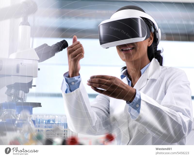 Female scientist using virtual reality to understand a research experiment in the laboratory glasses specs Eye Glasses spectacles Eyeglasses occupation