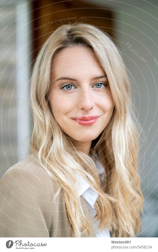 Close-up of smiling female entrepreneur with blond hair in office color image colour image Germany Millennials Millennial Generation young adults Adults grownup