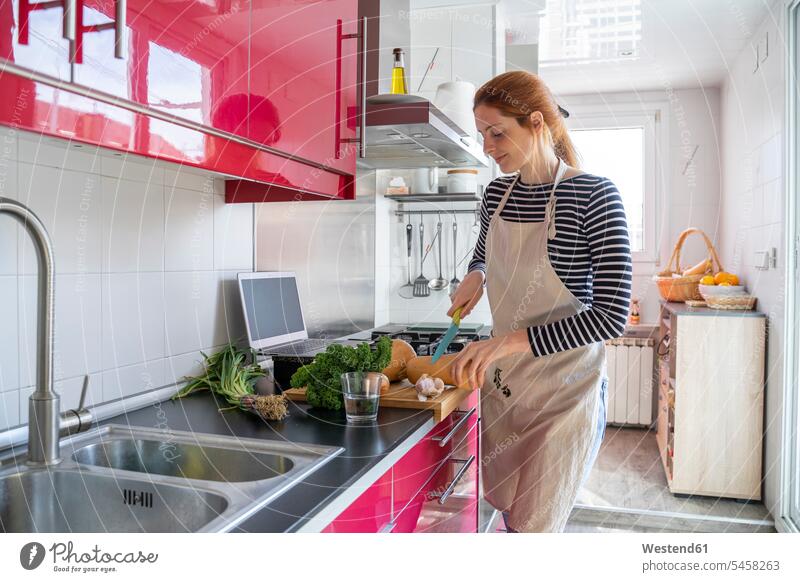 Young woman cooking healthy meal, using inline recipes human human being human beings humans person persons adult grown-up grown-ups grownup grownups young