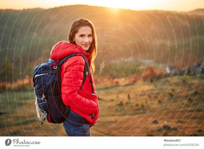 Portrait of smiling woman on a hiking trip in the mountains excursion Getaway Trip Tours Trips mountain range mountain ranges females women portrait portraits