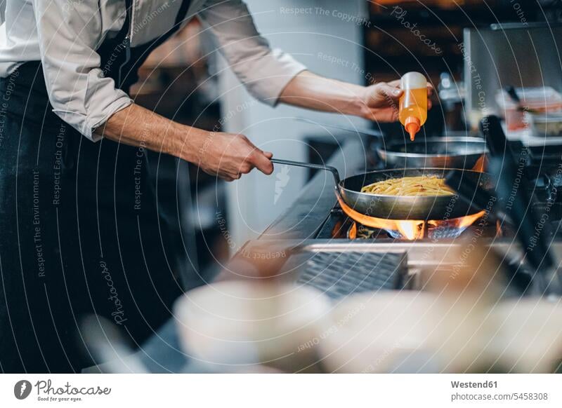 Chef preparing a dish in traditional Italian restaurant kitchen Occupation Work job jobs profession professional occupation Chefs cook cooks devices Cookers