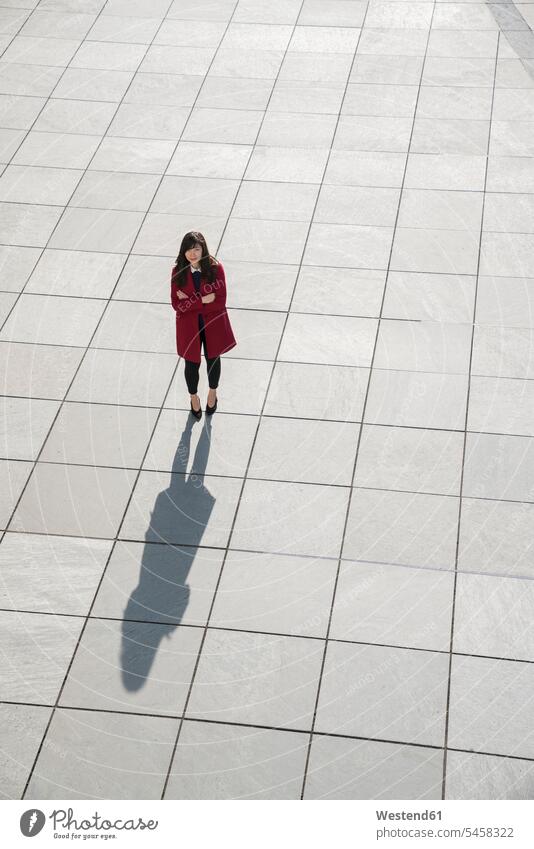 View from above of walking modern businesswoman standing on concrete floor human human being human beings humans person persons Asian Asians 1 one person only