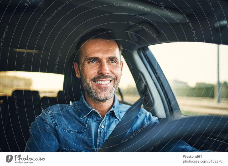 Handsome man driving a car human human being human beings humans person persons caucasian appearance caucasian ethnicity european 1 one person only