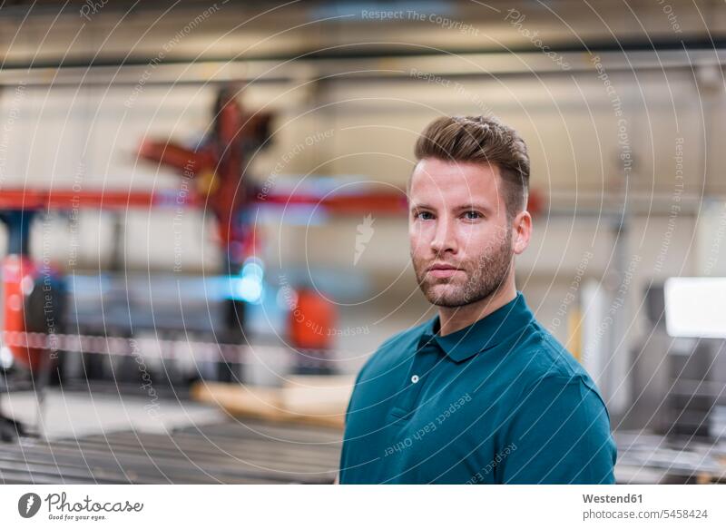 Portrait of confident man on factory shop floor confidence portrait portraits men males factories production hall Adults grown-ups grownups adult people persons