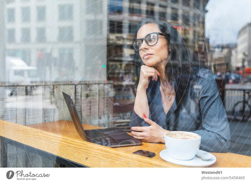 Business woman having a break in a cafe and working with a laptop human human being human beings humans person persons caucasian appearance caucasian ethnicity