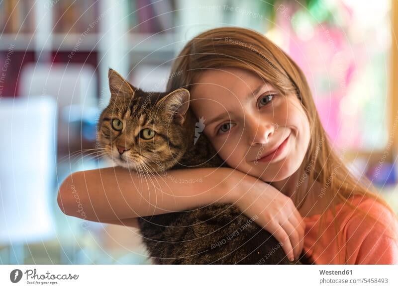 Portrait of smiling girl with her tabby cat cats portrait portraits smile females girls pets animal creatures animals child children kid kids people persons