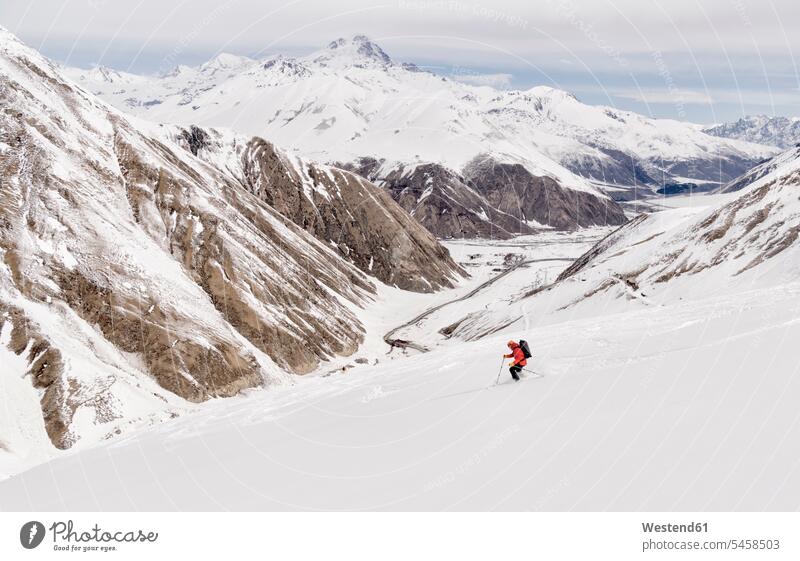Georgia, Caucasus, Gudauri, man on a ski tour riding downhill distant long distance Recreational Pursuit Recreational Activities Recreational Pursuits
