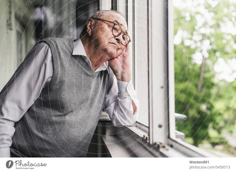 Portrait of sad senior man looking out of window human human being human beings humans person persons celibate celibates singles solitary people solitary person
