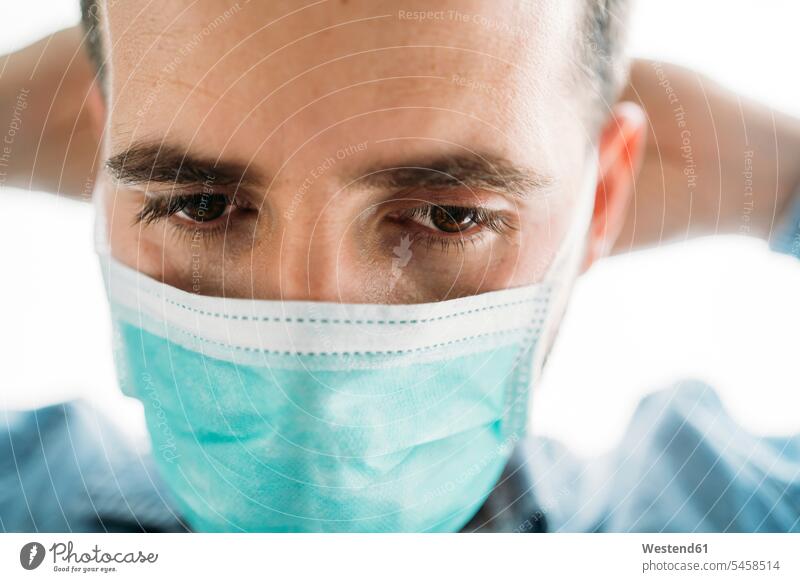 Close-up of businessman wearing protective mask during coronavirus outbreak, Almeria, Spain, Europe color image colour image indoors indoor shot indoor shots