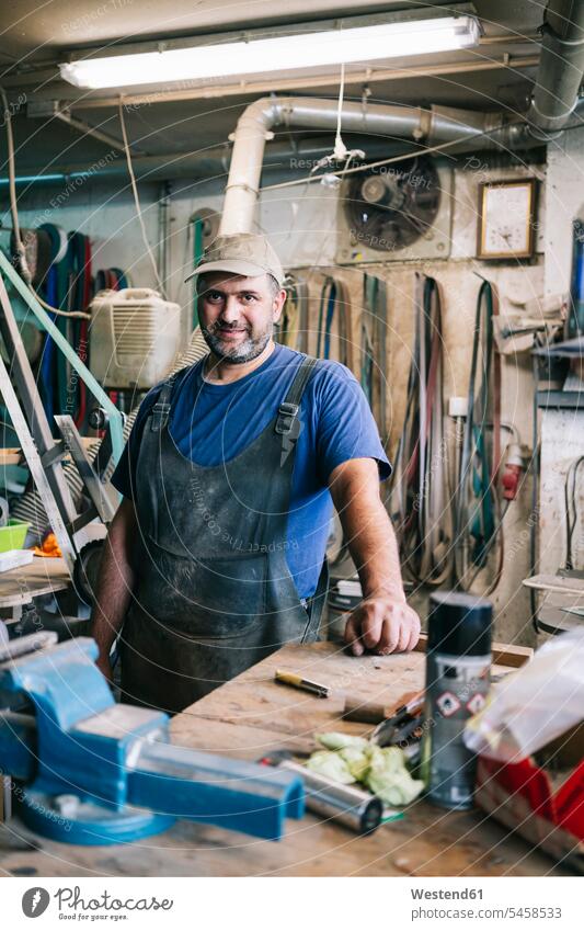 Portrait of a confident knife maker in his workshop Occupation Work job jobs profession professional occupation work cloth work clothes workwear overalls