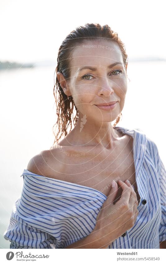 Portrait of mature woman with wet hair at a lake human human being human beings humans person persons caucasian appearance caucasian ethnicity european 1