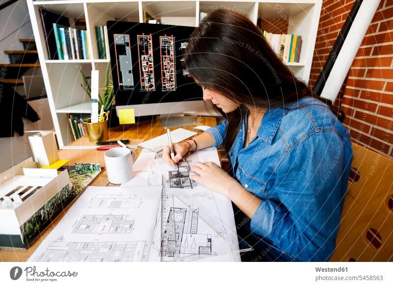 Young woman working in architecture office, drawing blueprints Blueprint Blueprints Building Plan architectural drawing Construction Plan designing sketch