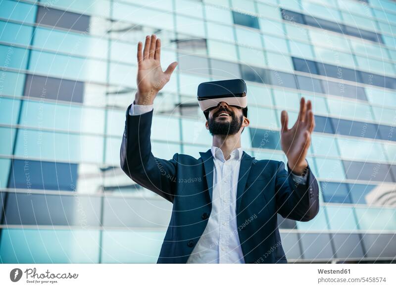 Businessman using virtual reality glasses outside office building specs Eye Glasses spectacles Eyeglasses office buildings VR Business man Businessmen