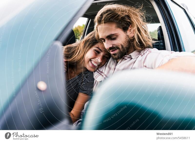 Happy young couple in a car twosomes partnership couples automobile Auto cars motorcars Automobiles Affection Affectionate happiness happy people persons