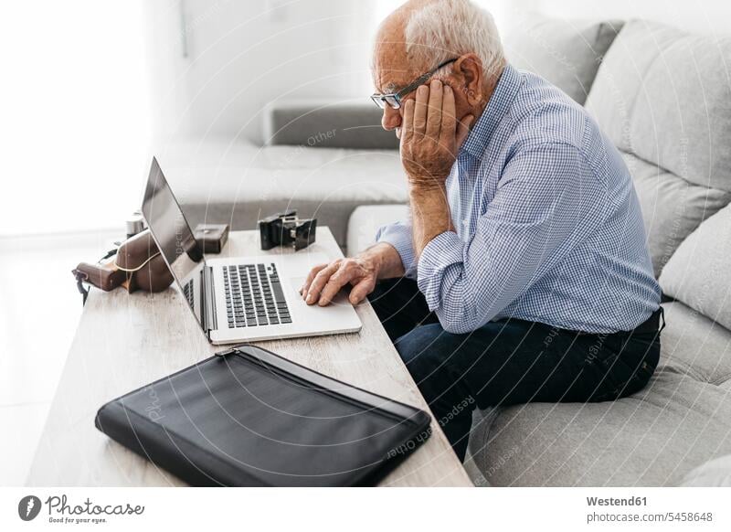 Senior man using laptop, old photo cameras senior men senior man elder man elder men senior citizen hobby hobbies wireless Wireless Connection