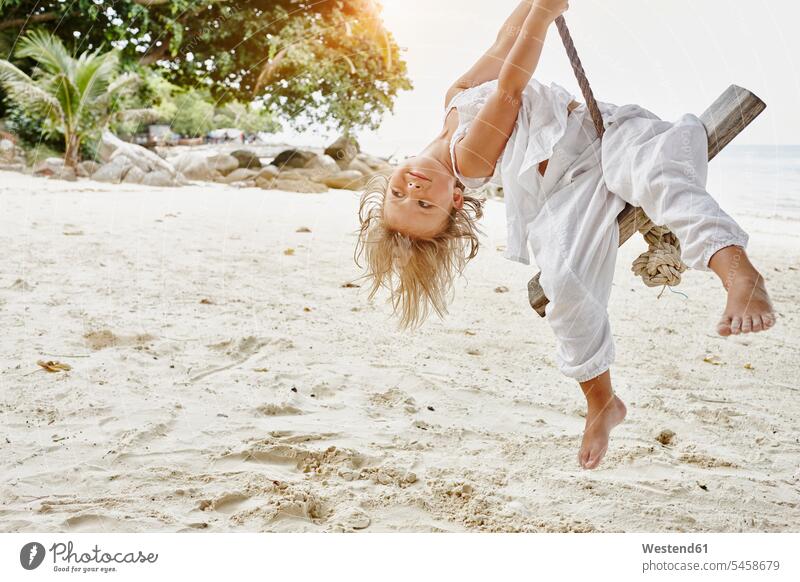 Thailand, Phi Phi Islands, Ko Phi Phi, little girl on a rope swing on the beach ropes swing set playground swing swingset beaches swinging rock rocking females