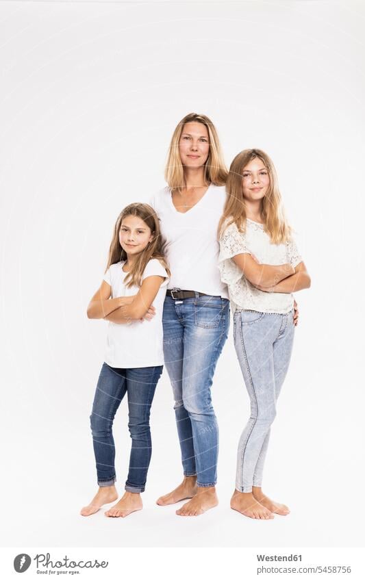 Mother with daughters standing against white background color image colour image casual clothing casual wear leisure wear casual clothes Casual Attire