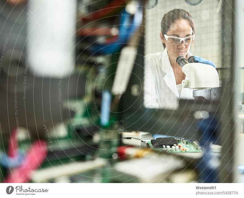Female technician working with microscope in research laboratory female technician female technicians technology technologies engineering female researcher