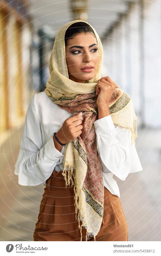 Spain, Granada, young muslim woman wearing hijab in urban city background Muslim Islam Hijab walking going urban scene headscarf head scarf head scarves