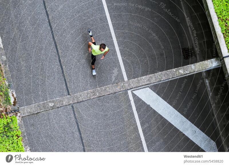 Top view of man running on a street men males road streets roads Adults grown-ups grownups adult people persons human being humans human beings Germany training