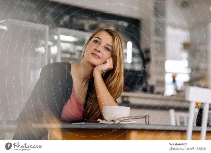 Portrait of daydreaming young woman in a cafe human human being human beings humans person persons caucasian appearance caucasian ethnicity european 1